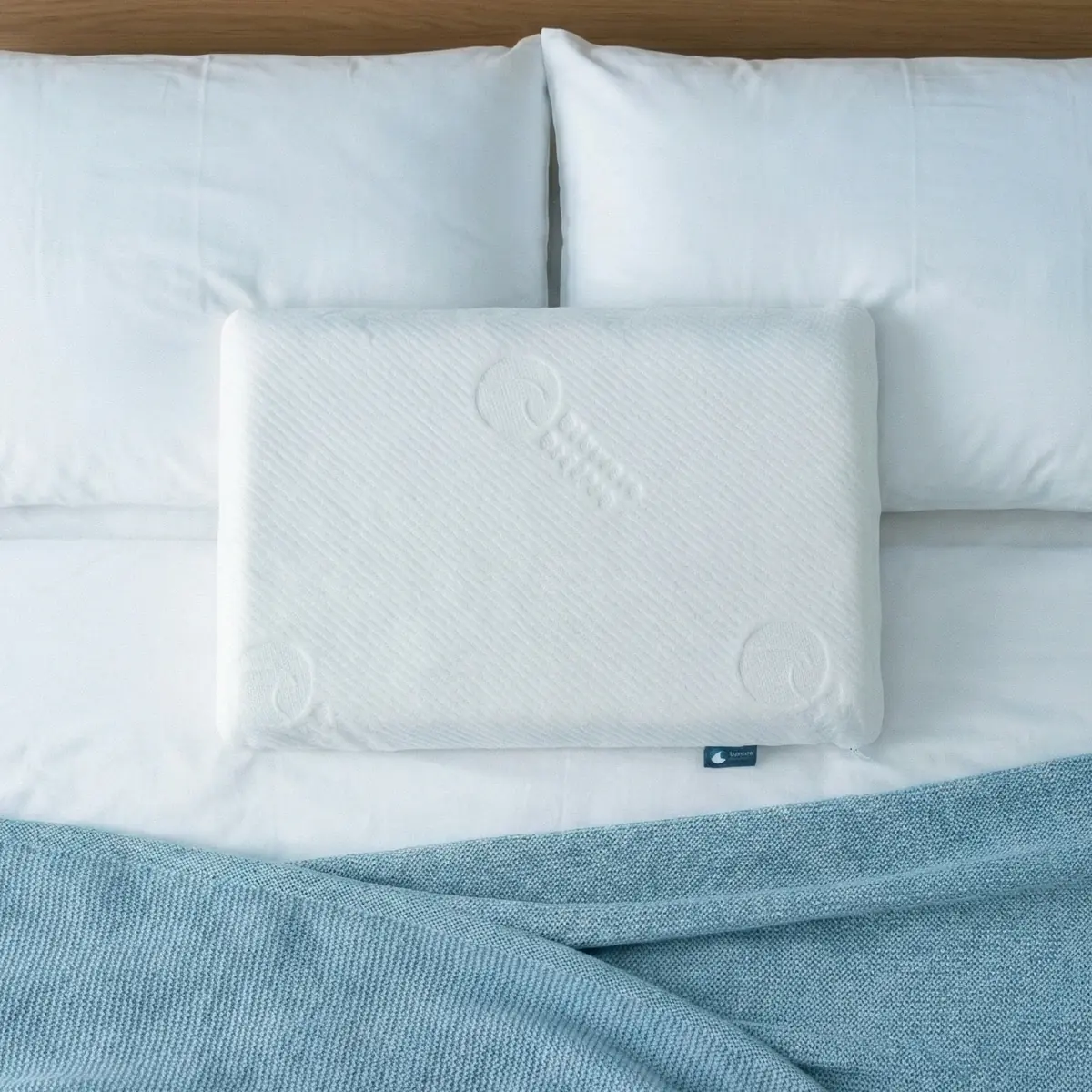 Bluewave Slim Series thin memory foam pillow on bed